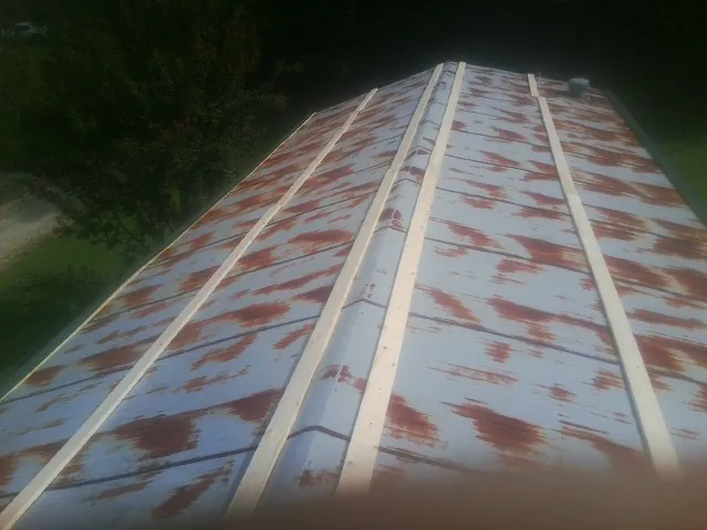 Rusted metal roof panels with new wood purlins before replacement — Storm Damage Roof Repair in Lady Lake by Roofing Brothers